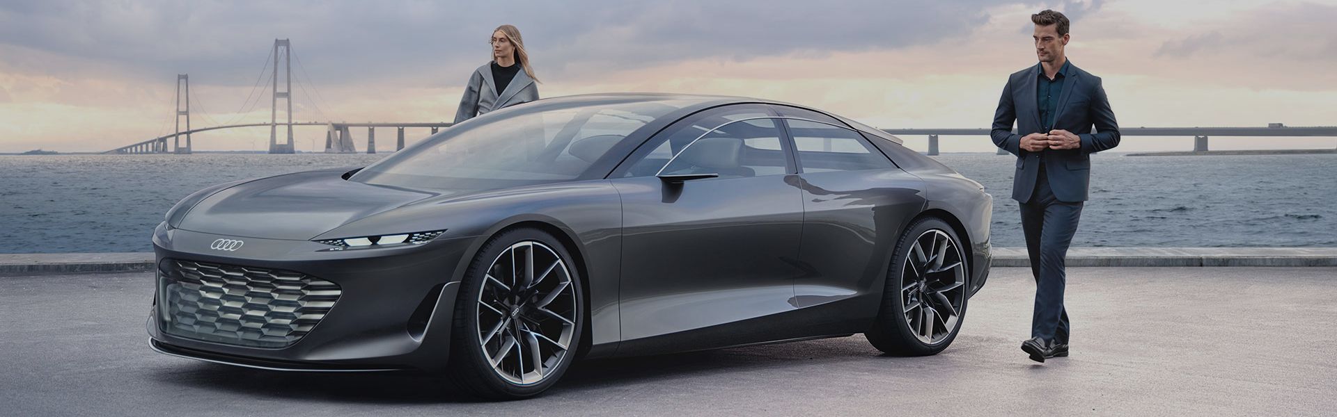 Man and woman next to Audi grandsphere concept